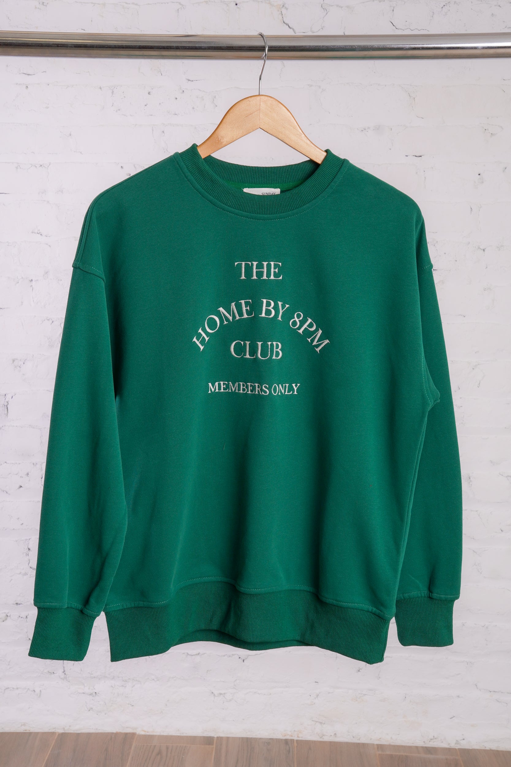 Green sweatshirt with text Homebody 8pm Club