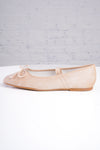 Beige ballet flats on a light gray background