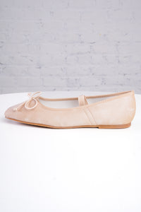 Beige ballet flats on a light gray background