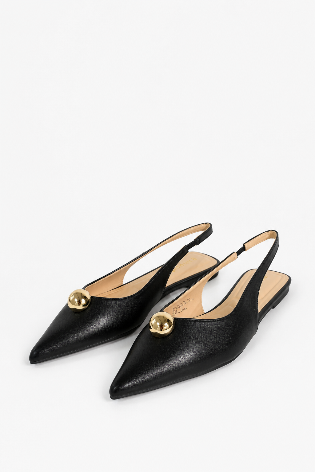 A pair of black leather pointed-toe slingback flats with gold-tone circular hardware on the toe, displayed on a clean white background.