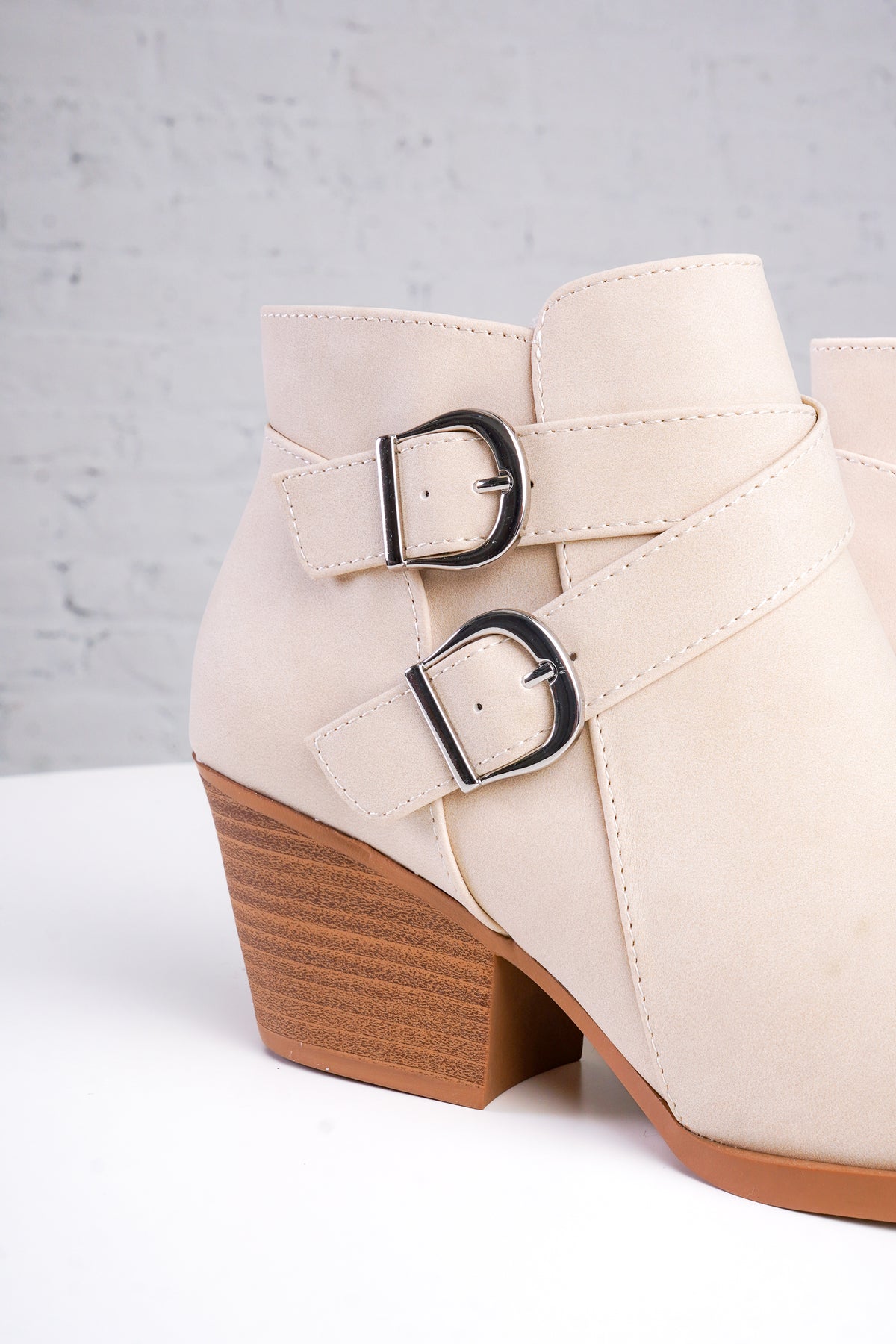 beige ankle boots with wooden soles with two buckles 
