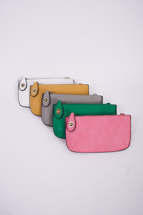 Photo shows a crossbody/ wristlet in many colors on a white background