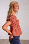rust puff sleeve peplum top with embroidered flowers 