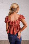 rust puff sleeve peplum top with embroidered flowers 