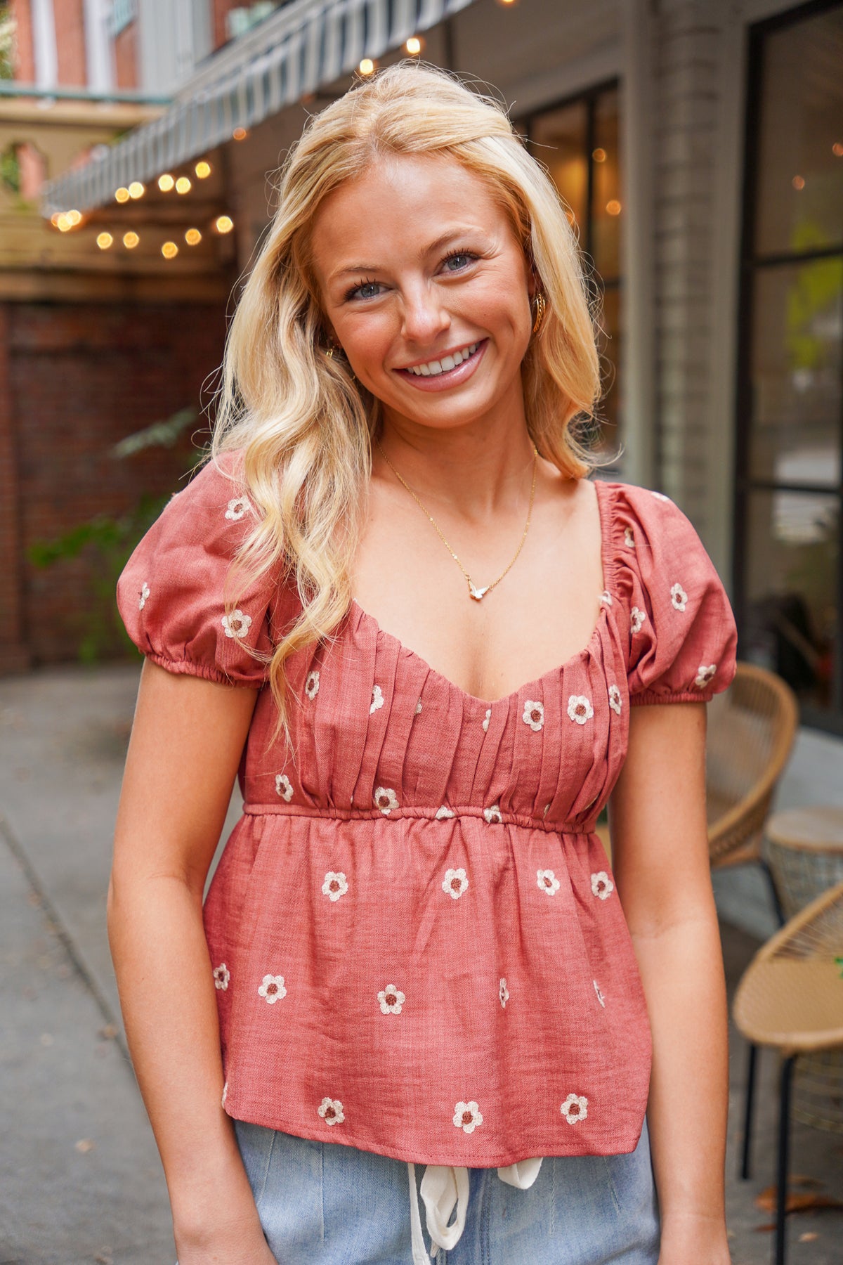 rust puff sleeve peplum top with embroidered flowers 