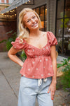 rust puff sleeve peplum top with embroidered flowers 