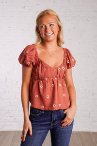 rust puff sleeve peplum top with embroidered flowers 