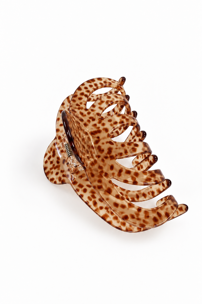 A tortoiseshell hair claw clip with a brown and tan spotted pattern