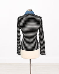A black and white horizontally striped long-sleeve knit top displayed on a dress form mannequin, featuring a contrasting light blue collar, set against a plain white background.