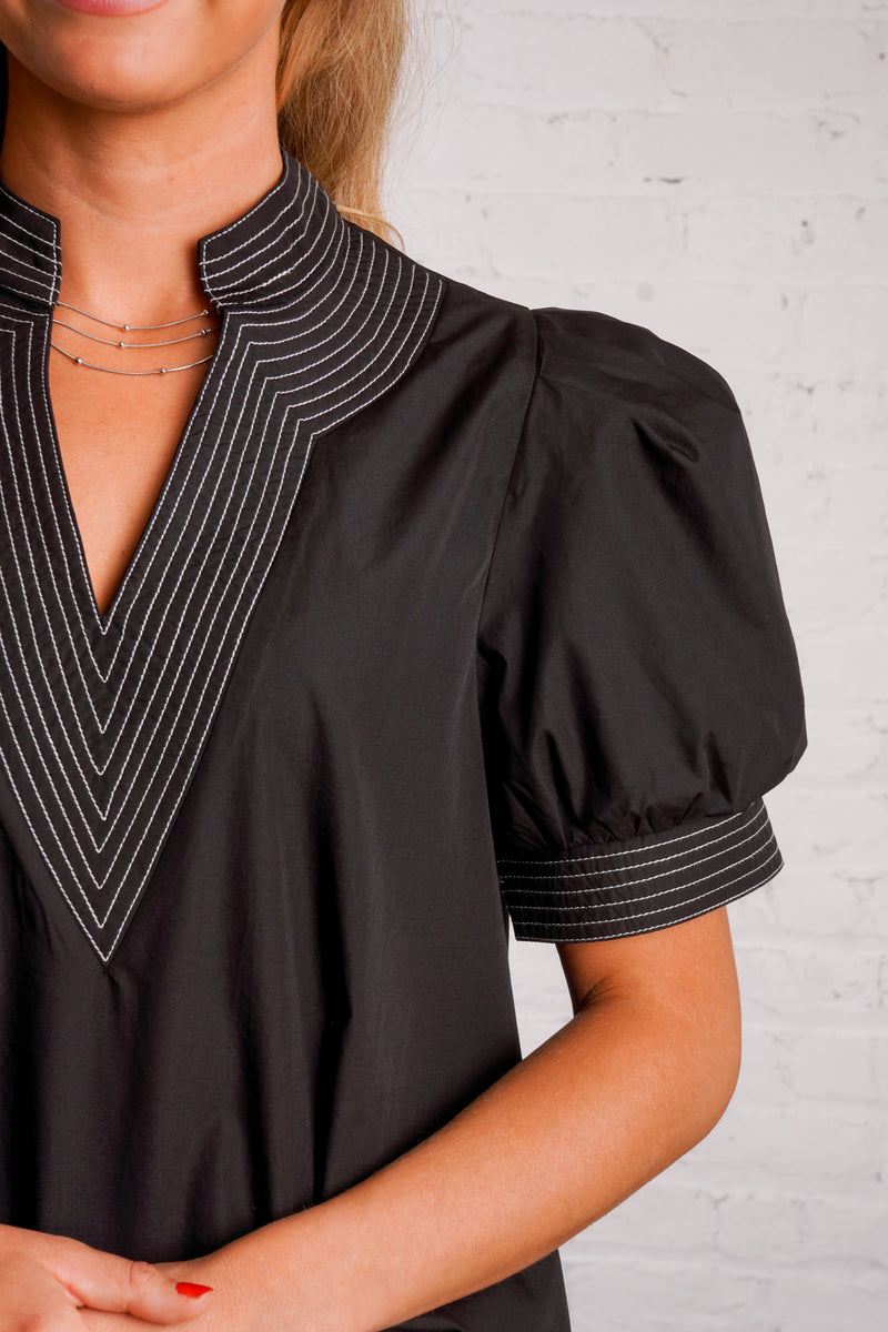 Black v-neck top with white stitching detail 