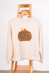 A cream-colored crewneck sweatshirt with a leopard-print pumpkin graphic on the front