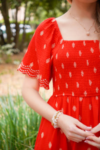 red midi dress with gold polka dots embroidered