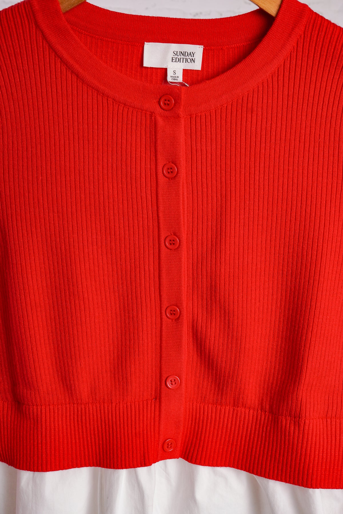 Red cardigan with a white cotton peplum bottom 