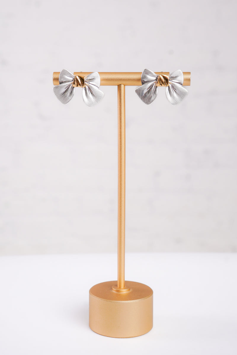 Silver bow-shaped earrings with gold centers 