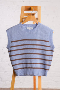 Sleeveless, crew neck, sky blue sweater vest with brown horizontal stripes. 