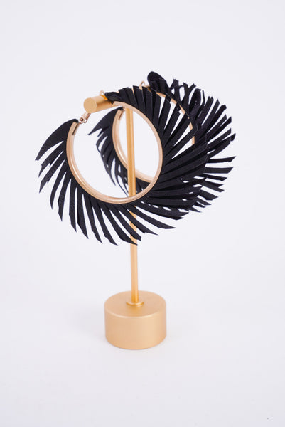 Photo shows a pair of black feather hoops made from a faux leather material.
