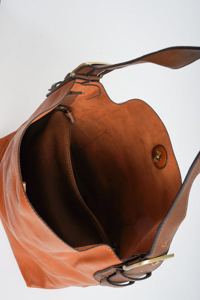 An inside detail shot of the inside of a brown hobo bag. 