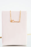 A dainty gold necklace with the word 
