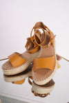Photo shows a pair of tan espadrille wedges on a mirror